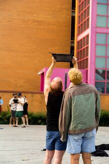 People in Nuclear Energy Plaza use AR to see the How do we trouble time exhibit