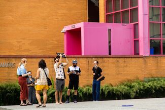 People in Nuclear Energy Plaza use AR to see the How do we trouble time exhibit