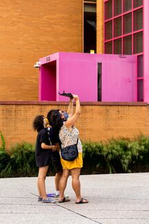 People in Nuclear Energy Plaza use AR to see the How do we trouble time exhibit