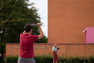 People in Nuclear Energy Plaza use AR to see the How do we trouble time exhibit