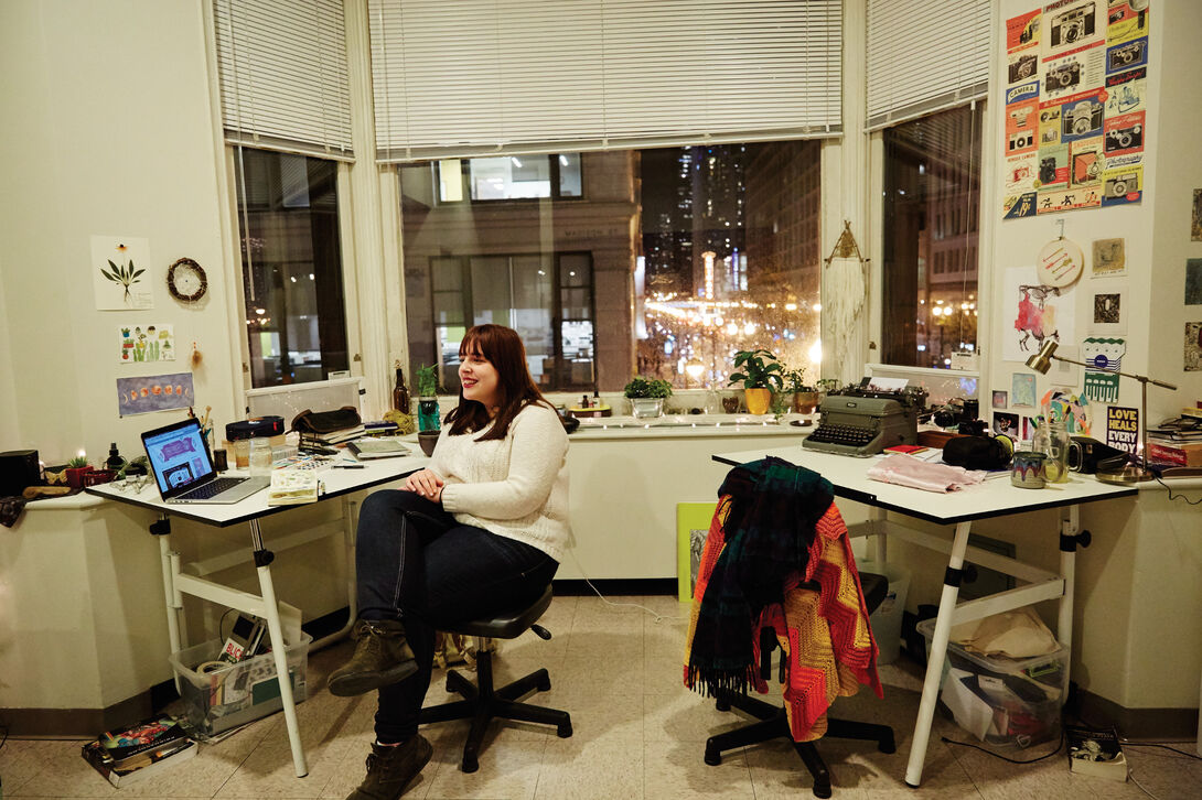 A student sitting in their dorm room. 