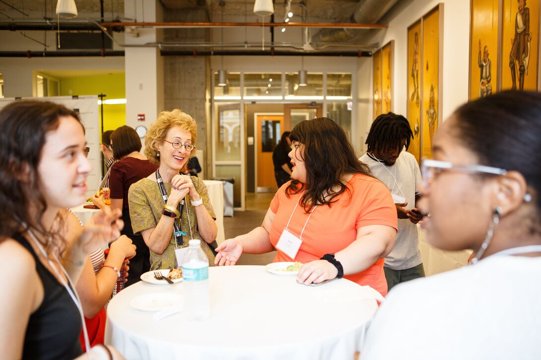 SAIC students, staff, and faculty conversing at an SAIC scholars event