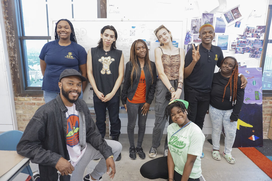 Class instructor and students in the youth class posing for a group shot in a classroom.