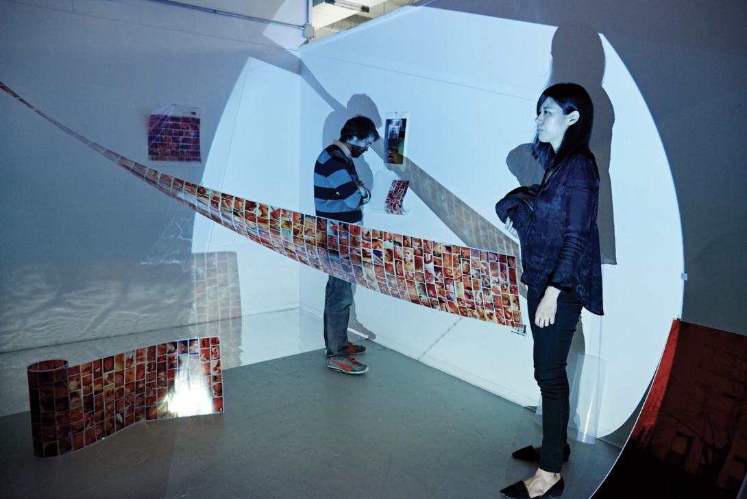Two people standing in a gallery.
