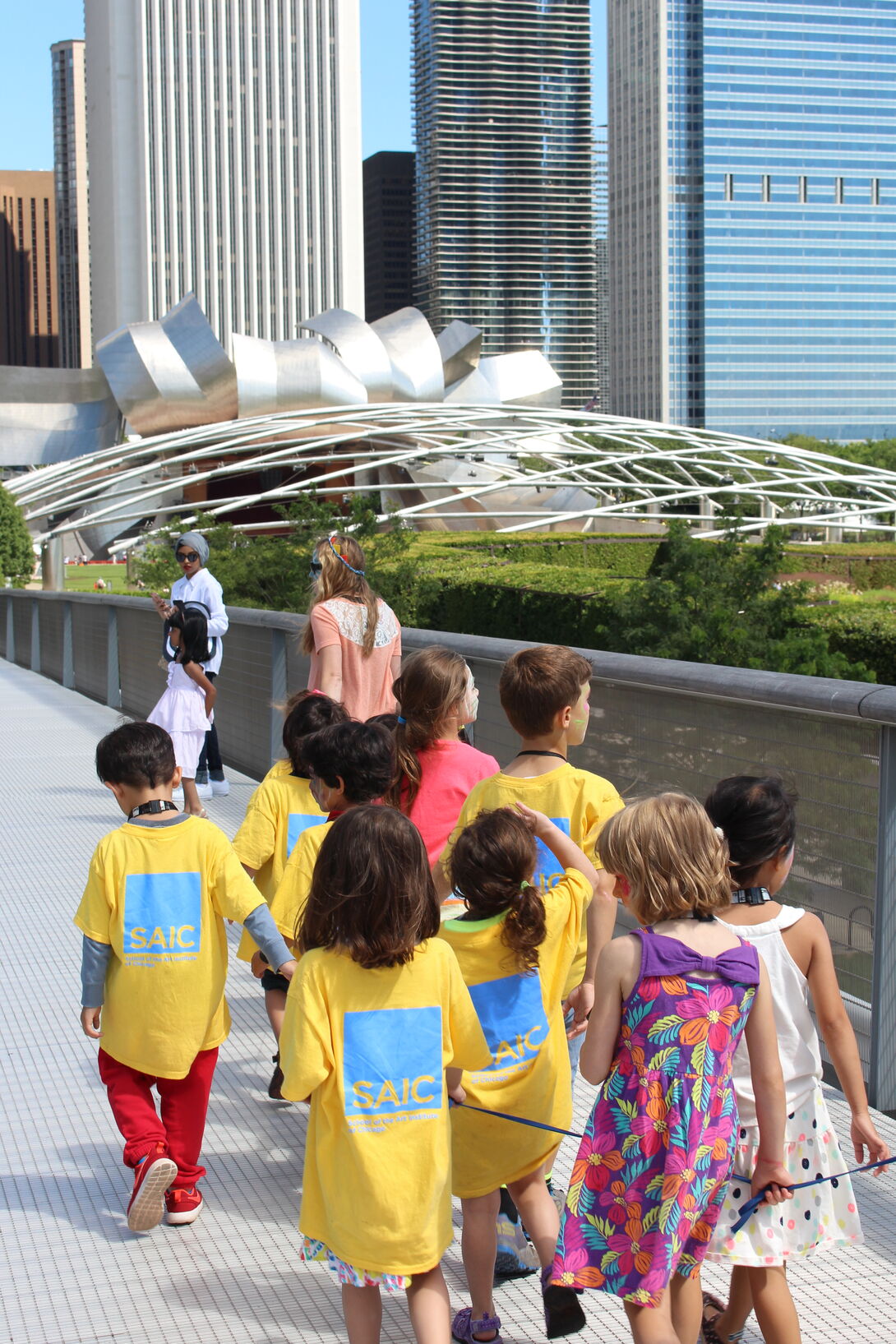 A small group of young students walking in Millennium Park.