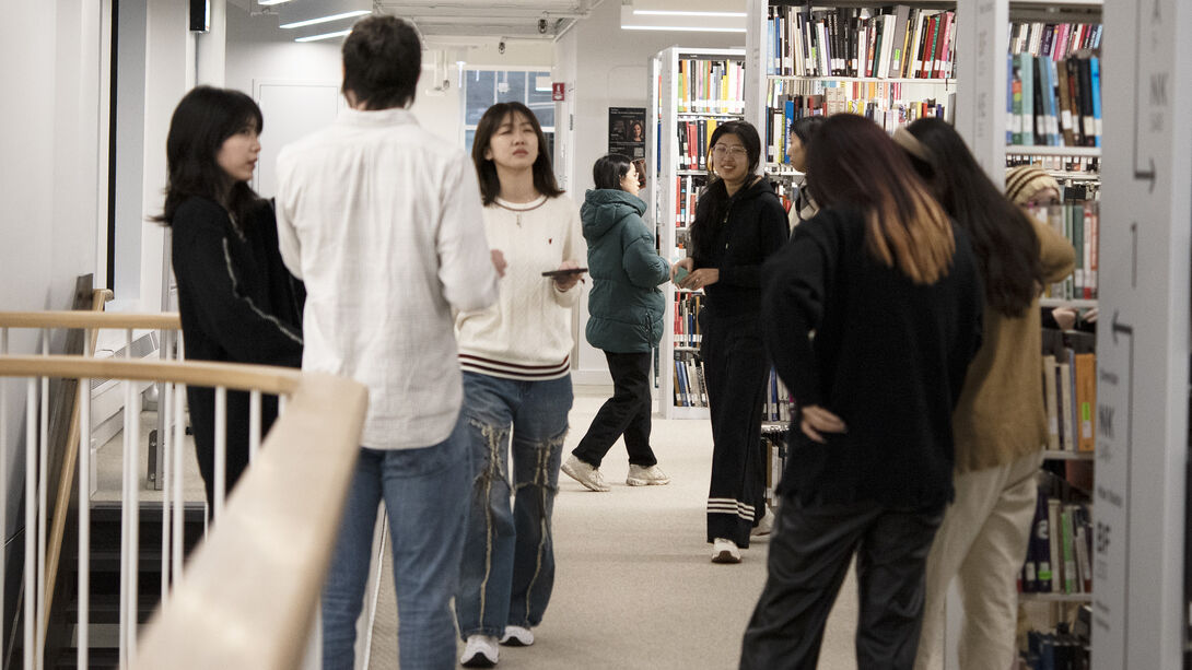 Students standing in a library