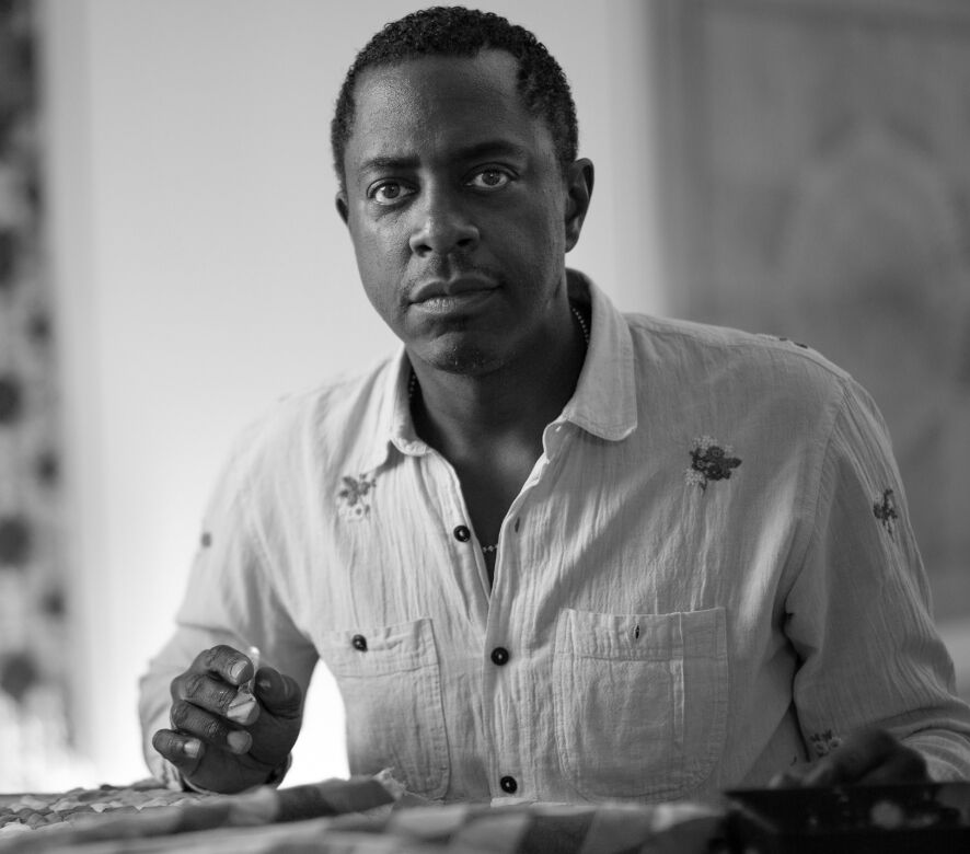 a black and white headshot of Sanford Biggers