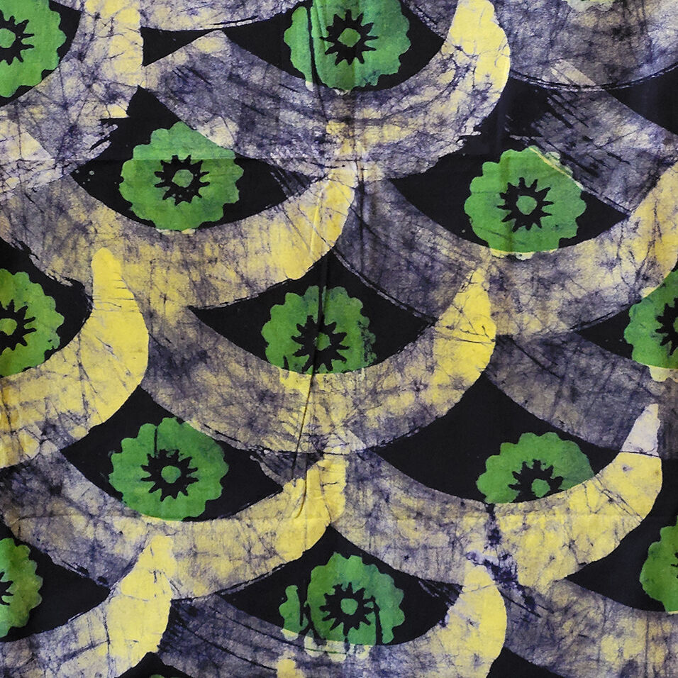 Wax resist repat pattern featuring green flowers and purple and yellow bananas with crackle effect.