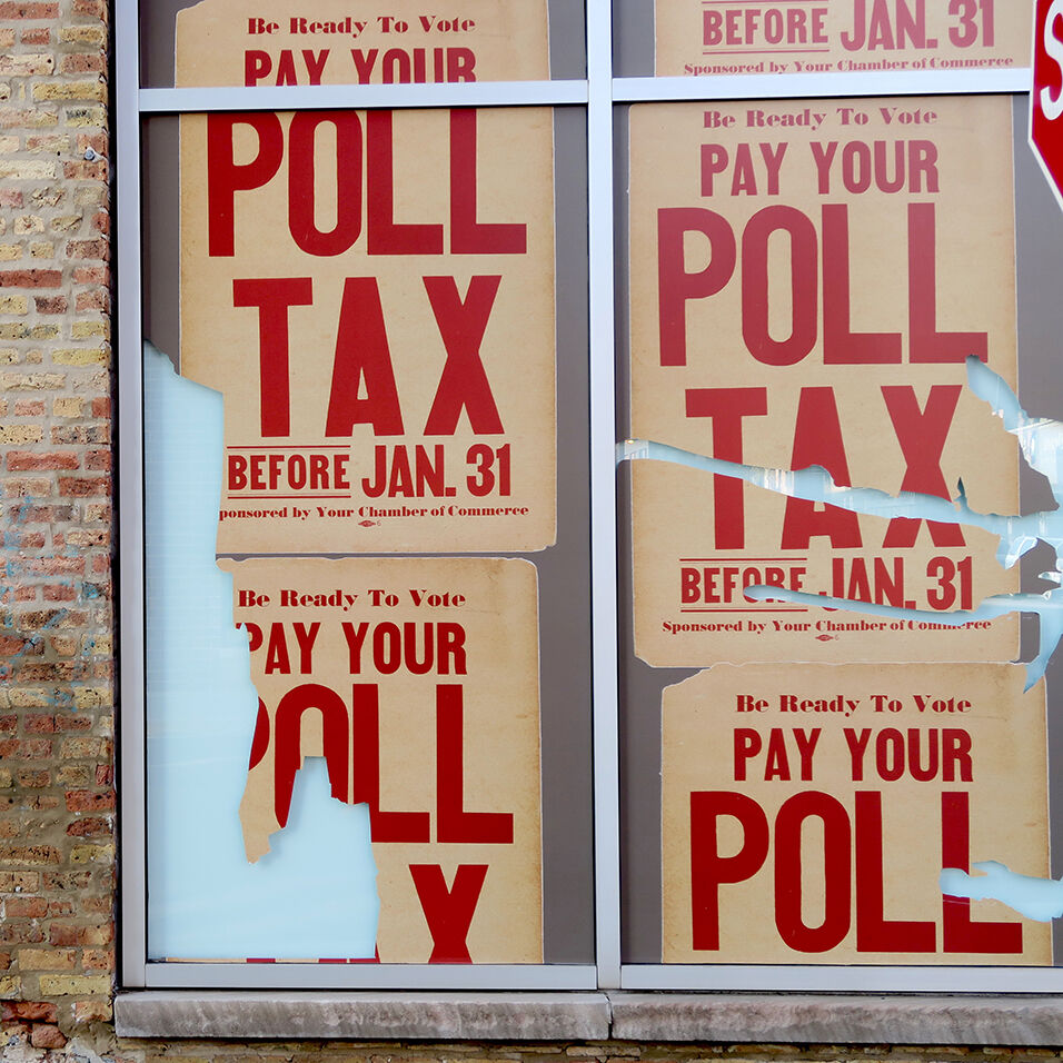 4 copies of the same poster hung in a window. Red text on a cream background reads: "Pay Your Poll Tax" in all-caps.