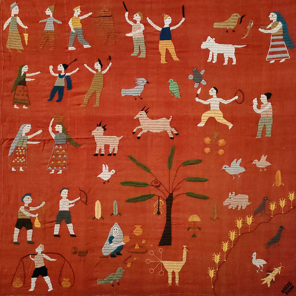 Detail of rust-colored textile with embroidered human and animal figuresdancing and standing around a tree.