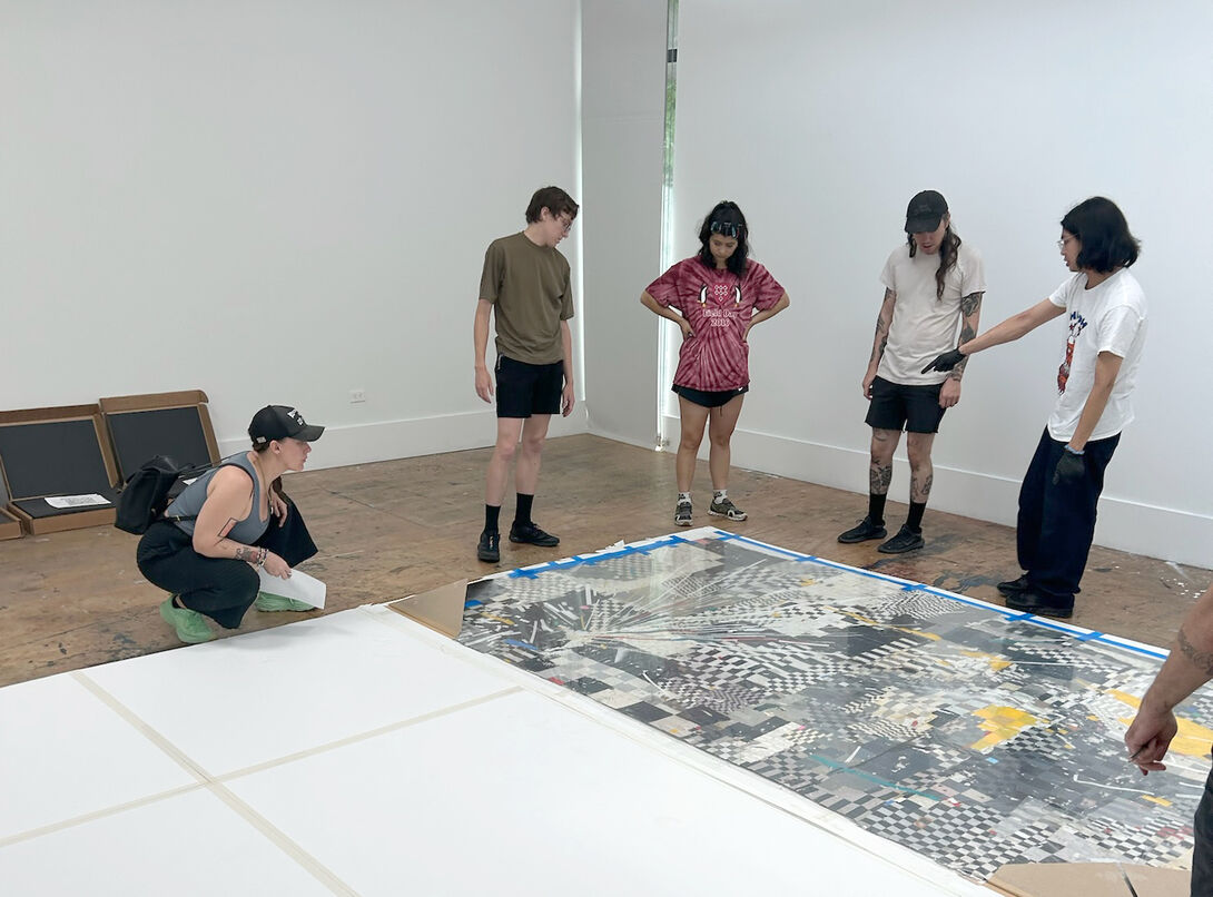 students installing artwork