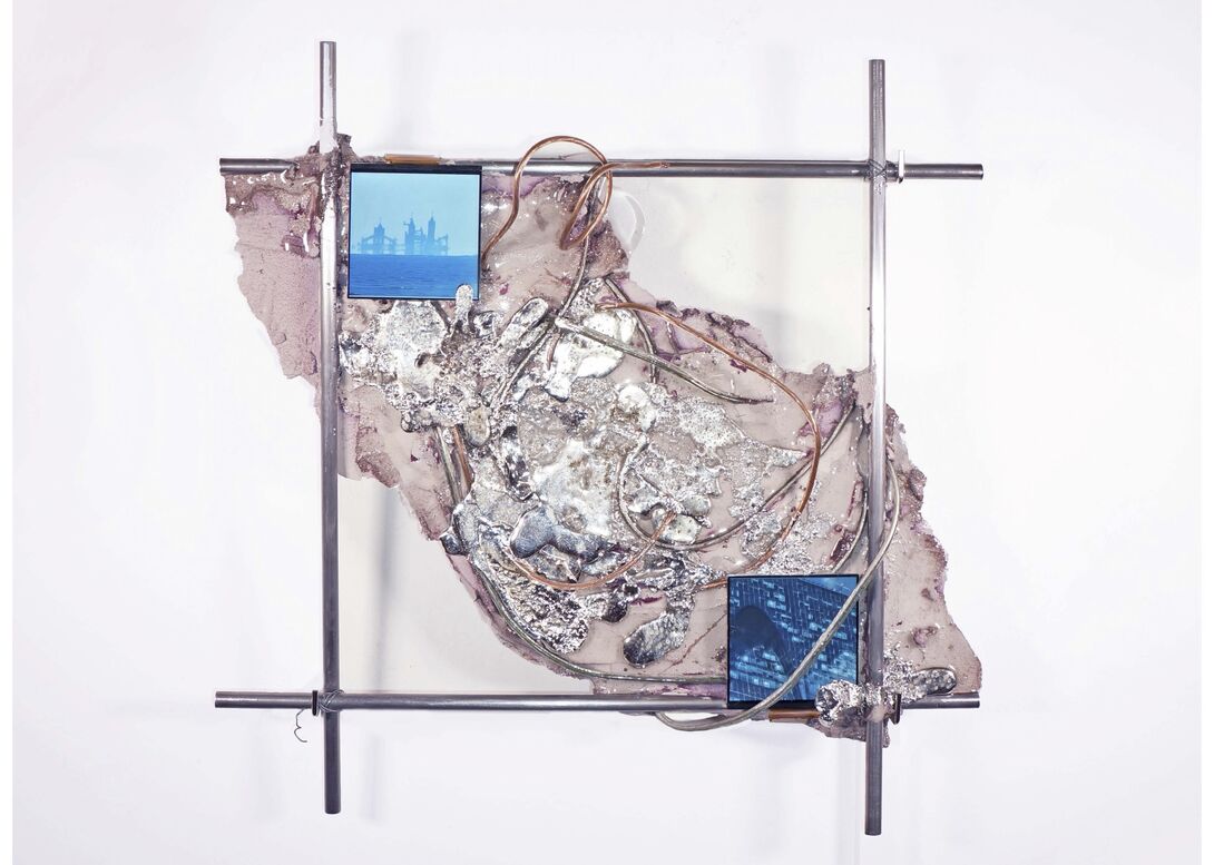 Wall-mounted installation with a steel frame supporting layered concrete, resin, and tin, wrapped with cable and translucent tubing. Two LCD screens embedded in the surface display blue-toned, AI-generated video imagery.