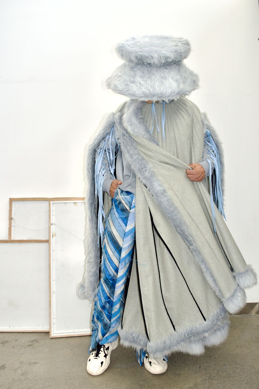 A figure in a fur-trimmed blue outfit