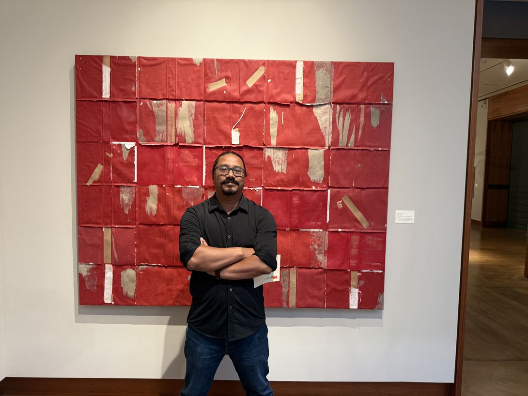Bishal Manandhar in front of his art