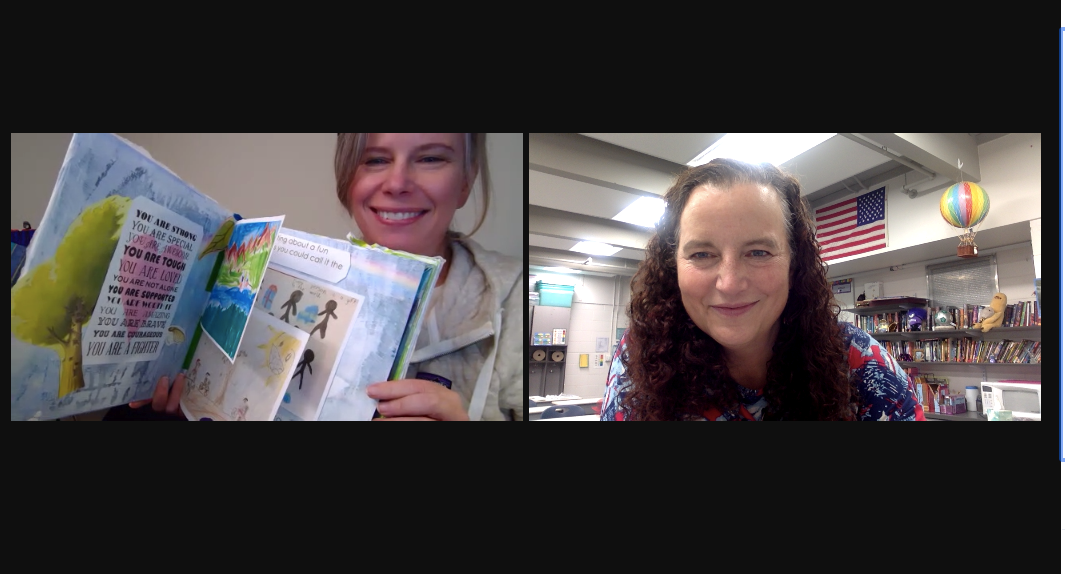 Two women on a Zoom call, one holding up a book of student artwork