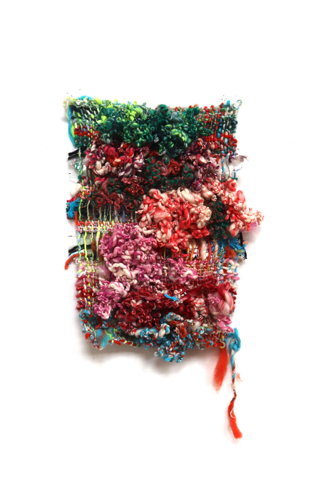 A piece of brightly colored, knit fiber art on a white background