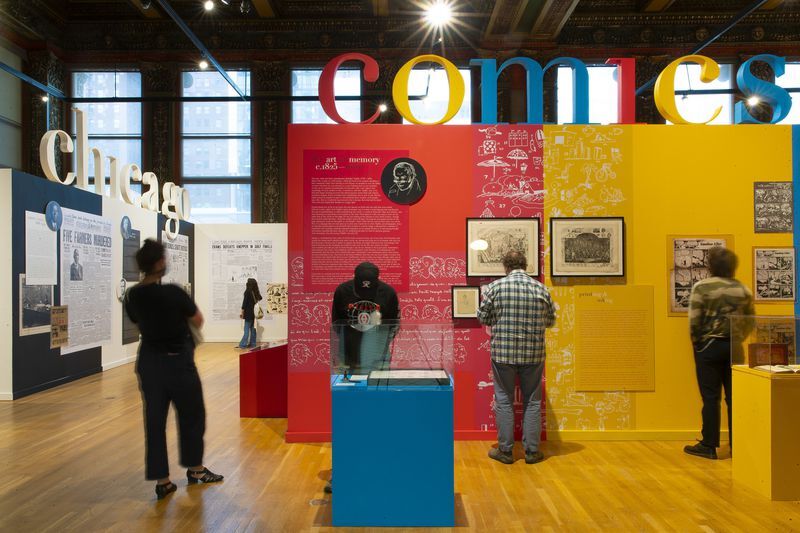 Ware's Chicago: Where Comics Came to Life (1880-1960) Several guests looking at the colorful walls of Ware's exhibition