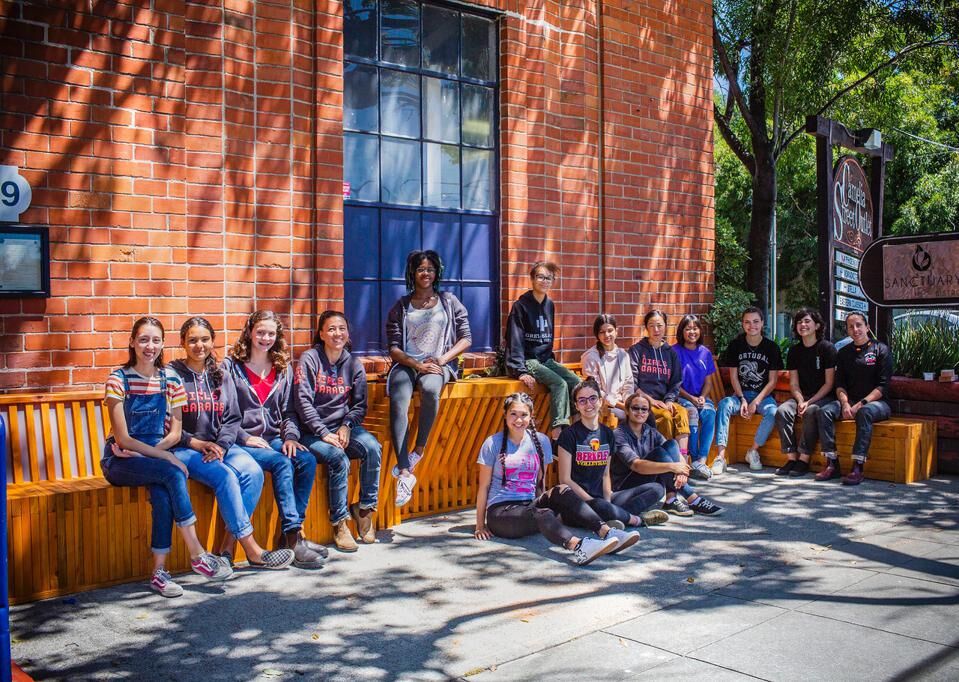 Girls outside of a brick building