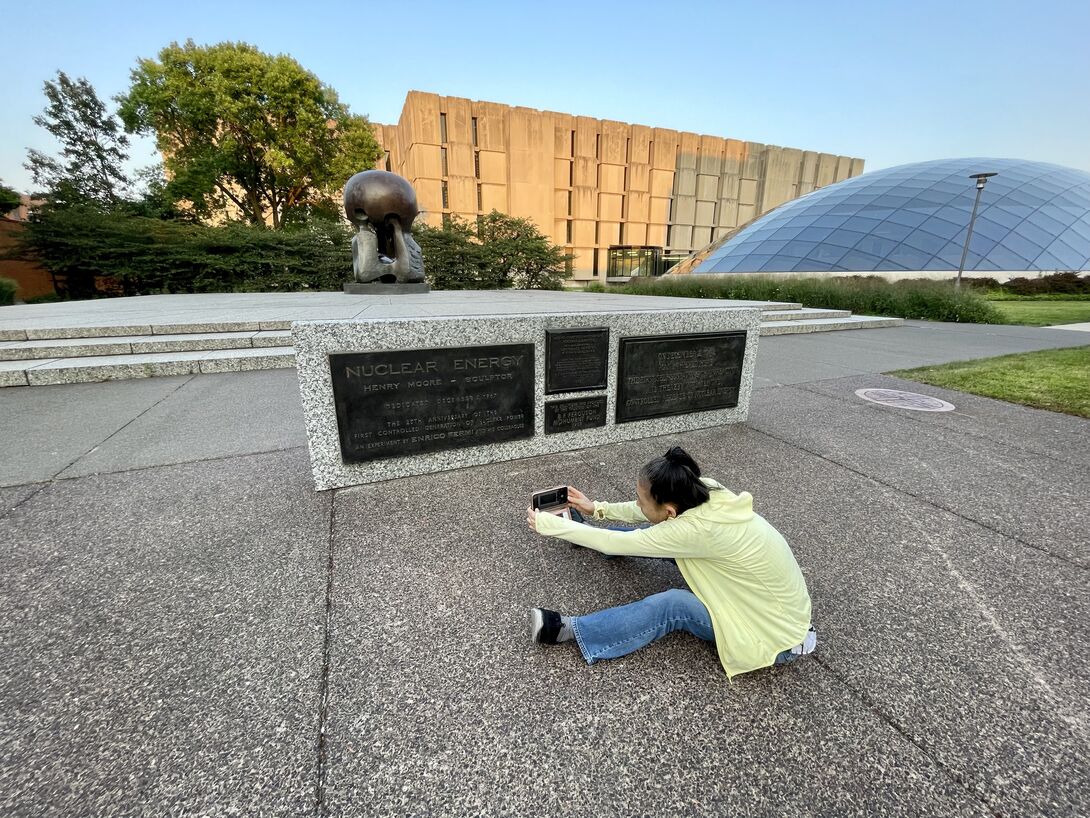 Eiko Otake takes a picture in Nuclear Energy Plaza