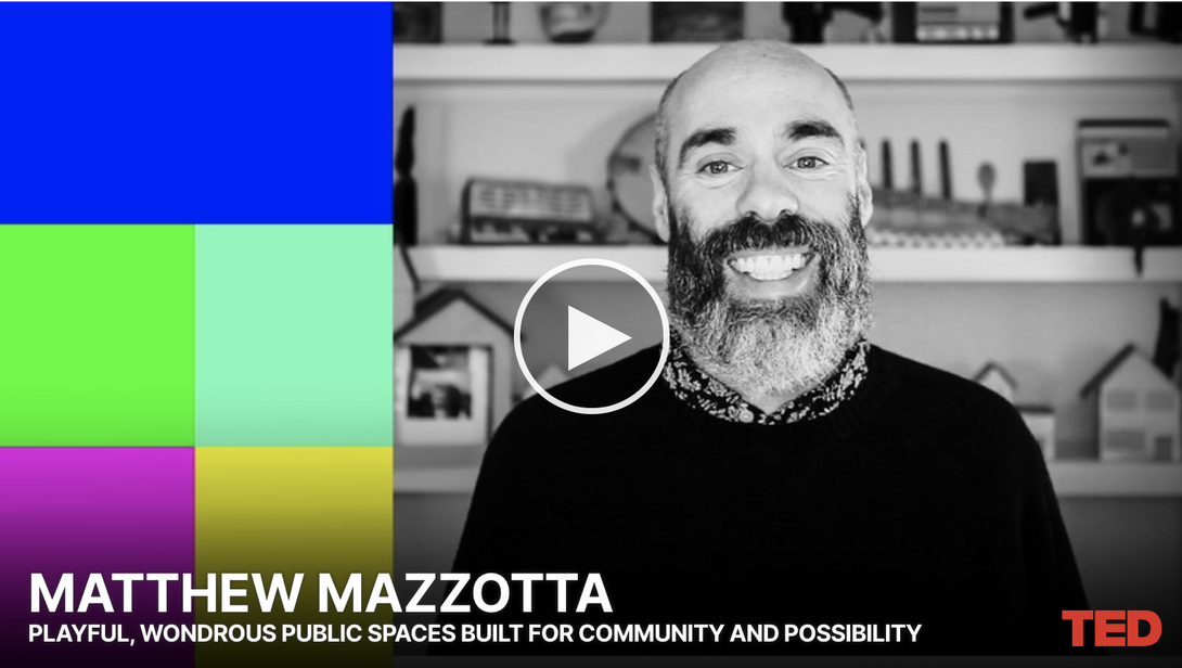 A video still of a black and white photo of a man and colorful blocks, with Matthew Mazzotta written in text beneath it