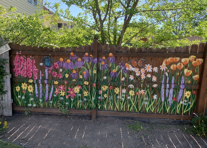 An image of flowers painted on a fence